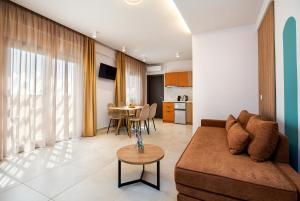 a living room with a couch and a table at SerèNova Luxury Suites in Limenaria
