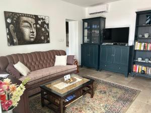 a living room with a couch and a coffee table at Relaxxa Apartman in Noszvaj