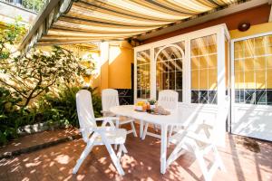 a white table and chairs on a patio at Green Home in Recco