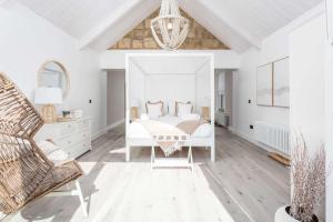 a white bedroom with a bed and a chair at No36 South Beach - Donnini Apartments in Troon +101 photos