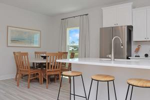 a kitchen with a counter and a table and chairs at Salty Beaches by Pristine Property Vacation Rentals in Saint Joe Beach