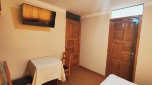 a small room with a table and a door at El Álamo in Arequipa