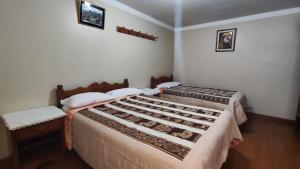 Un dormitorio con dos camas en una habitación. en El Álamo, en Arequipa