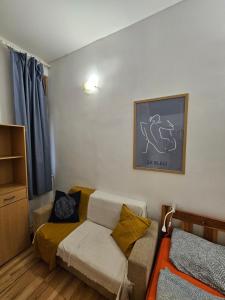 a small room with a bed and a couch at Vibrant City Center Rooms in Budapest