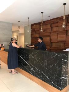a man and a woman standing at a counter at Cityscape Grand Tower Condo, studio unit in Cebu City +13 photos