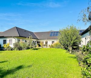 a house with a large yard with a green lawn at Retz Garden Loft in Retz