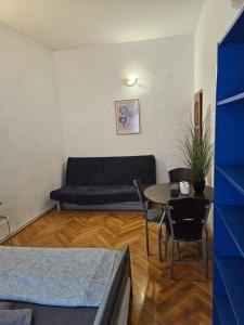 a living room with a couch and a table at Vibrant City Center Rooms in Budapest