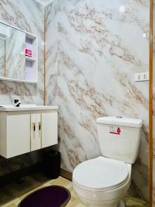 a bathroom with a white toilet and a sink at Chilltop Homestay in Baguio +19 photos