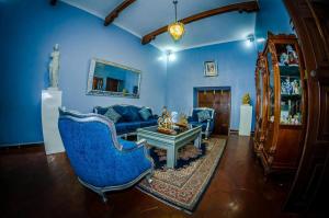 a blue living room with a blue couch and a table at Gran Bolivar Hotel - Trujillo, Perú in Trujillo