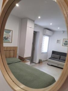a bedroom with a bed and a couch at LV Home Lasithi in Agios Georgios