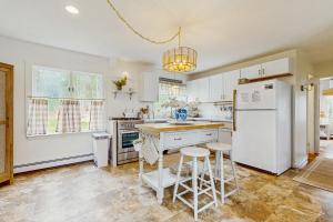 a kitchen with a white refrigerator and two stools at Willow Cove in York