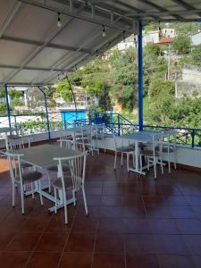 a group of tables and chairs on a patio at Guesthouse Mili in Piqeras