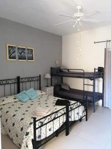 a bedroom with two bunk beds and a ceiling fan at Affittacamere D&D in Porto San Paolo