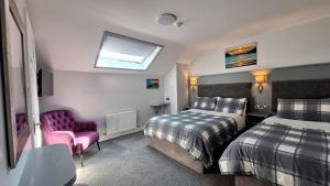 a hotel room with two beds and a window at Murphy's Guesthouse in Dingle