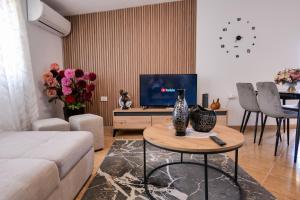 a living room with a couch and a table at Xhejn's Veranda 7 in Durrës