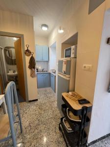 a small kitchen with a table and a refrigerator at Casa Berri in Vejer de la Frontera