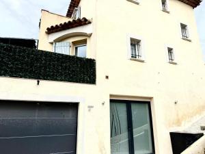 a white building with a black garage door at Appartment Jacuzzi in Cannes in Cannes