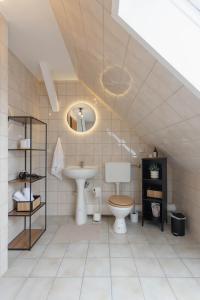 a bathroom with a sink and a toilet at gemütliches Stadtloft in Dessau in Dessau +15 photos