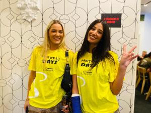 two women in yellow shirts standing next to a wall at Tequila Sunrise Podstel Brisbane in Brisbane