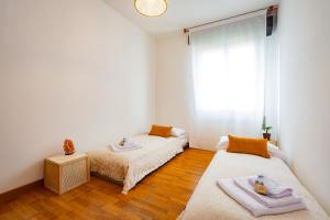 a bedroom with two beds and a window at Liviana Apartment Venice- Spacious,Free Parking,Easy Access to Venice in Marghera