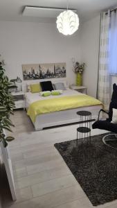 a bedroom with a bed and a table and a chair at Przytulny apartament 2 in Żywiec