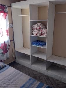a bedroom with a white book shelf with a bed at Casa Água da Rocha in Itaguaí