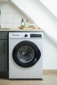 a white washing machine sitting in a kitchen at gemütliches Stadtloft in Dessau in Dessau