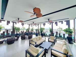 a lobby of a hotel with chairs and tables at Meritus in Perai