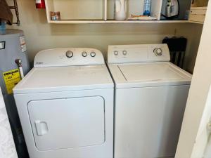 two white washing machines sitting next to each other at Serenity Now in Holden Beach +28 photos