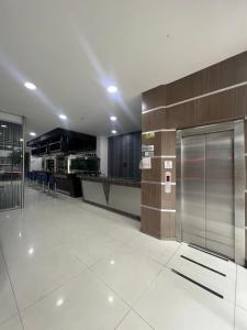 a large kitchen with a stainless steel refrigerator at Hotel Plaza Sport in Bogotá