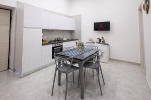 a kitchen with a table and chairs in a room at Palazzo Oberdan in Afragola