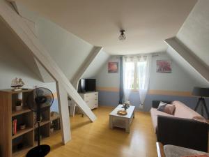 a living room with a couch and a table at Chez Jo in Le Luart