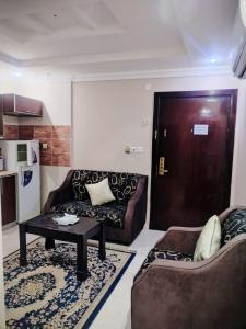 Una sala de estar con un sofá y una mesa y una puerta. en شقق الفرسان حى الفيصلية اماسي البشاير, en Yeda