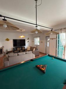 a living room with a pool table at Refúgio das Alfazemas in Vila Nova de Milfontes