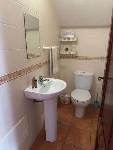 a bathroom with a sink and a toilet at Refúgio das Alfazemas in Vila Nova de Milfontes +26 photos