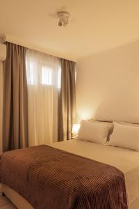 a bedroom with a bed and a window at Manolia house near beach, near airport in Aghia Marina