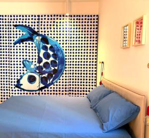 a bedroom with a bed with a fish on the wall at Studiò in Termoli +9 photos
