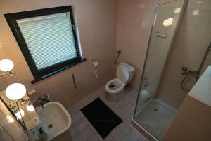 a bathroom with a toilet and a sink and a shower at Domek nad jeziorem in Kretowiny +44 photos