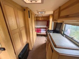 an interior view of a kitchen in an rv at Pole namiotowe u Józia in Borne Sulinowo