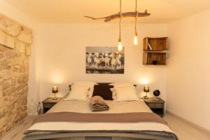 a bedroom with a large bed with two tables at Instant en Provence in Eyragues +117 photos