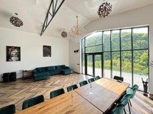 an open living room with a large table and chairs at Cabana Friends in Valea Inzelului +34 photos