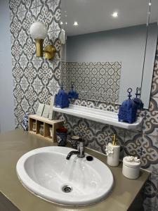 a bathroom with a sink and a mirror at Suite Une Bulle d Evidence avec baignoire spa in Saumur +39 photos