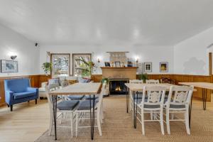 a dining room with tables and chairs and a fireplace at Tudors Village BNB in Fair Oaks