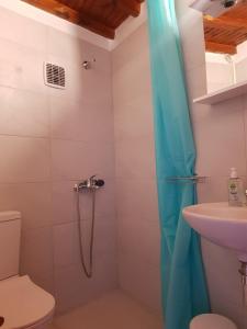 a bathroom with a shower with a toilet and a sink at Sunshine Studio Near New Port Of Mykonos in Mýkonos City