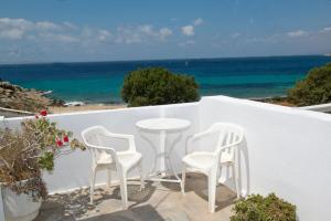 a table and two chairs on a balcony with the ocean at Sunshine Studio Near New Port Of Mykonos in Mýkonos City