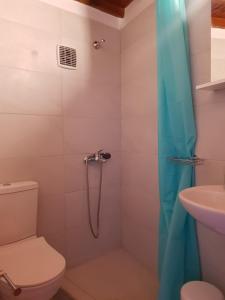 a bathroom with a shower with a toilet and a sink at Sunshine Studio Near New Port Of Mykonos in Mýkonos City