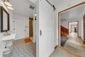 a bathroom with a toilet and a sink and a mirror at Tudors Village BNB in Fair Oaks +56 photos