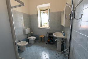 A bathroom at "Il Segreto" Vista Panoramica sulle Isole Eolie con Piscina, palestra e WiFi