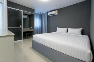a bedroom with a white bed and a bathroom at Siam Rama9 Hotel in Bangkok +82 photos