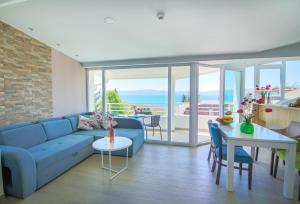 a living room with a blue couch and a table at Villa Jordan in Ohrid